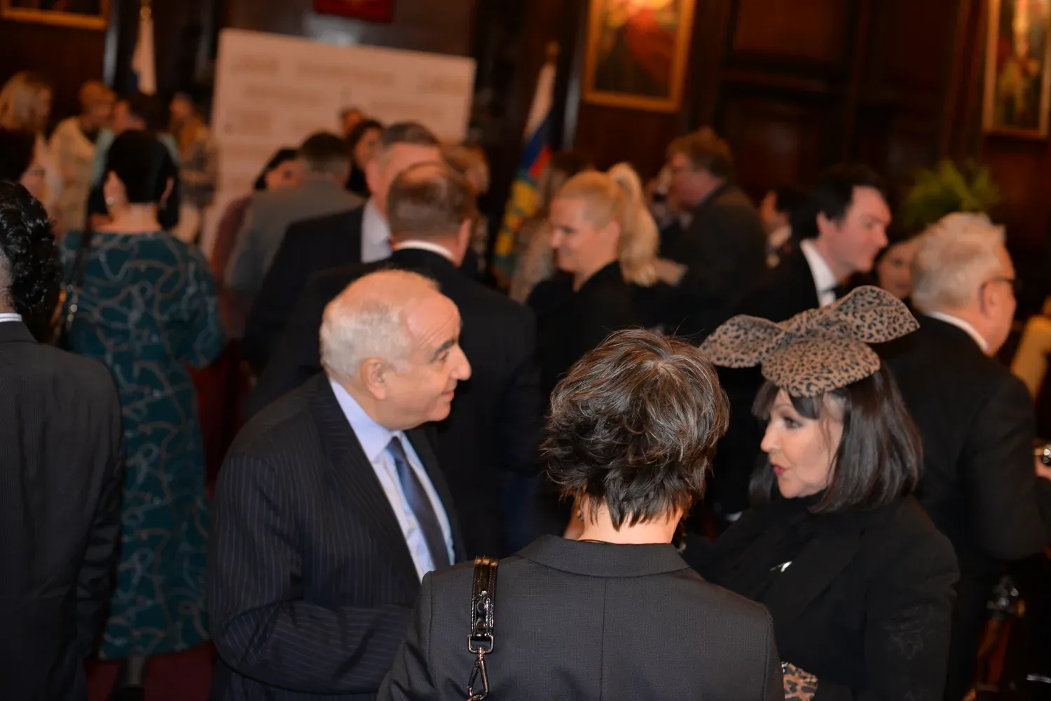 Guests mingling at a SIFFA reception in a wood-panelled London hall